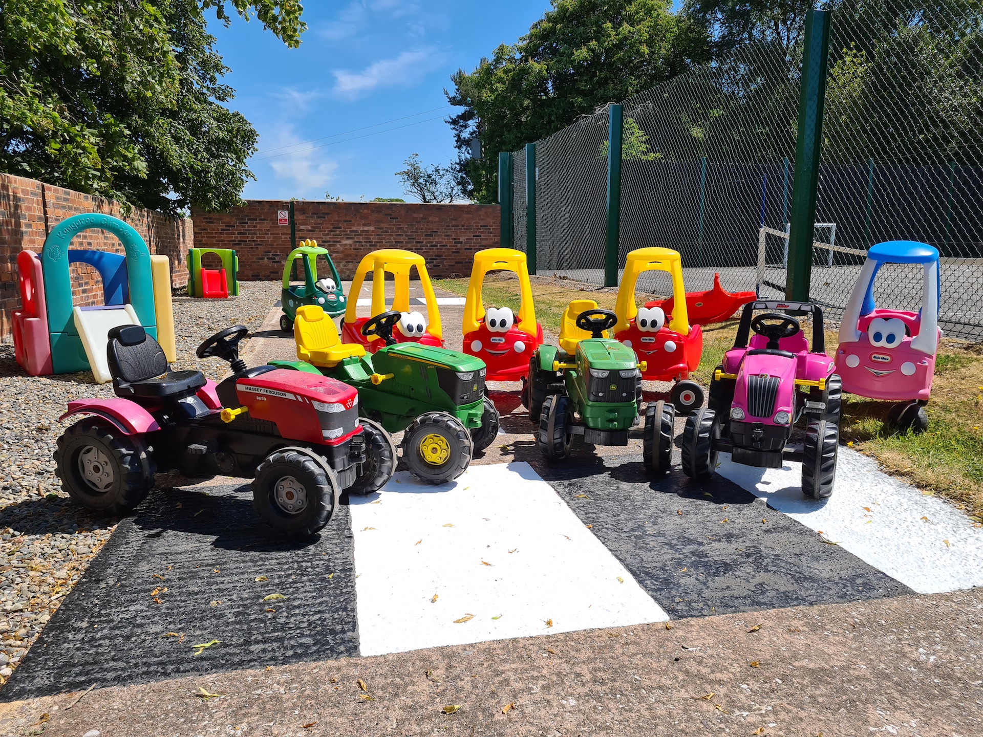 childrens pedal cars lined up in a Shropshire holiday cottage garden.