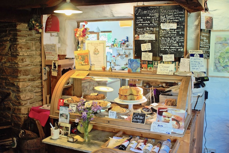 An Exmoor tearoom display cabinet featuring sweet and savoury scones, cakes and pies.