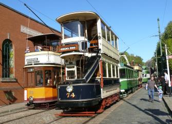 Three vintage trams on a sunny day at the Crich Tramway Village