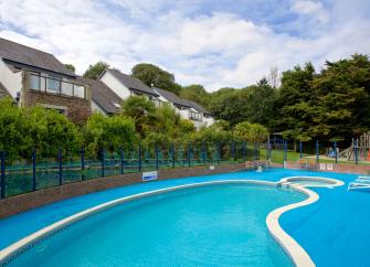 A kidney-shaped outdoor pool with attached plunge pool in Truro