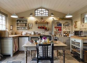 A well-equipped cottage kitchen with breakfast table.