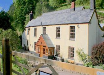 A large cottage overlooks the River Wye in a rural location.