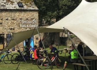 A  Yorkshire Dales tearooms in an open-sided tent being used by cyclists.