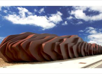  A large wooden beach sculpture - the exterior of a beach cafe in Seaton.