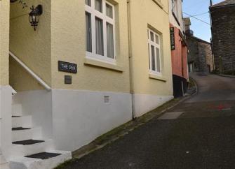 Exterior of a 3-storey townhouse on a quiet lane in Looe.