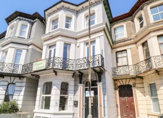 A Victorian terraced 2-storey townhouse with a balcony.
