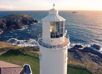 A lighthouse tower with rugged clifftop and ocean views