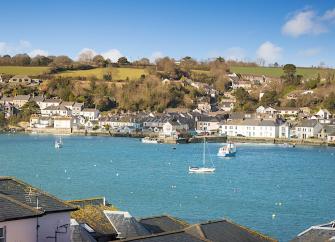 Falmouth waterfront lined with fishermen's cottages and waterside apartments.