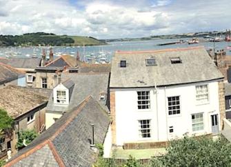 Aerial view of Marine Cottage in Falmouth looking across rooftops towards the sea.