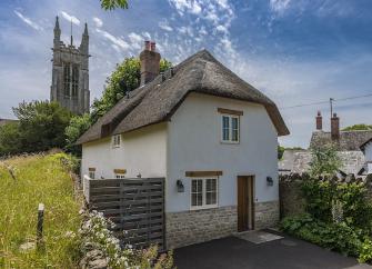 Exterior of a thatched village cottage in Dorset.
