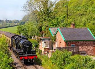 A steam engine glides by a Somerset holiday cottage on a summer's day.