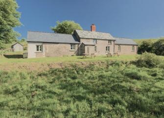 The exterior of a stone-built Exmoor farmhouse standing in a remote moorland location near Simonsbath.