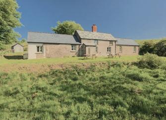 The exterior of a stone-built Exmoor farmhouse in a remote moorland location.