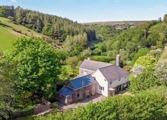 A large Exmoor holiday cottage nestles in a remote wooded valley.