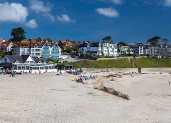 Luxury seafront apartments overlook a sandy beach in Falmouth.