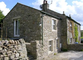A2-storey, end of terrace stone-built holiday cottage in Settle with a walled side garden.