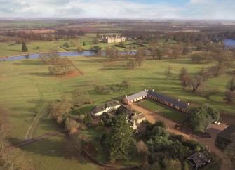 Aerial view of the flat Lincolnshire countryside with a groups of stable conversions surrounding a large courtyard 