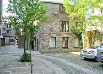 A 3-storey, stone-built holiday apartment in KEndal in a tree-lined courtyard.