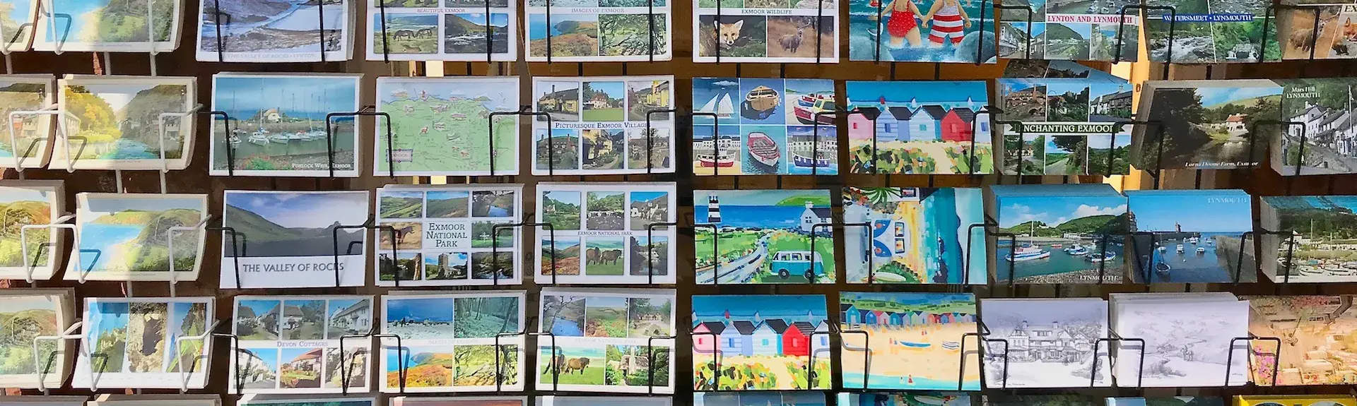 Close-up photo of a rack of North Devon and Exmoor postcards.