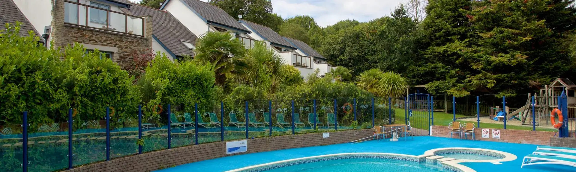 A kidney-shaped outdoor pool with attached plunge pool in Truro