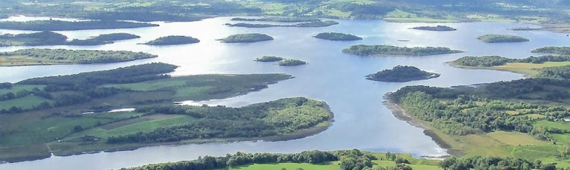 An aerial photo of a large lake dotted with tiny islands