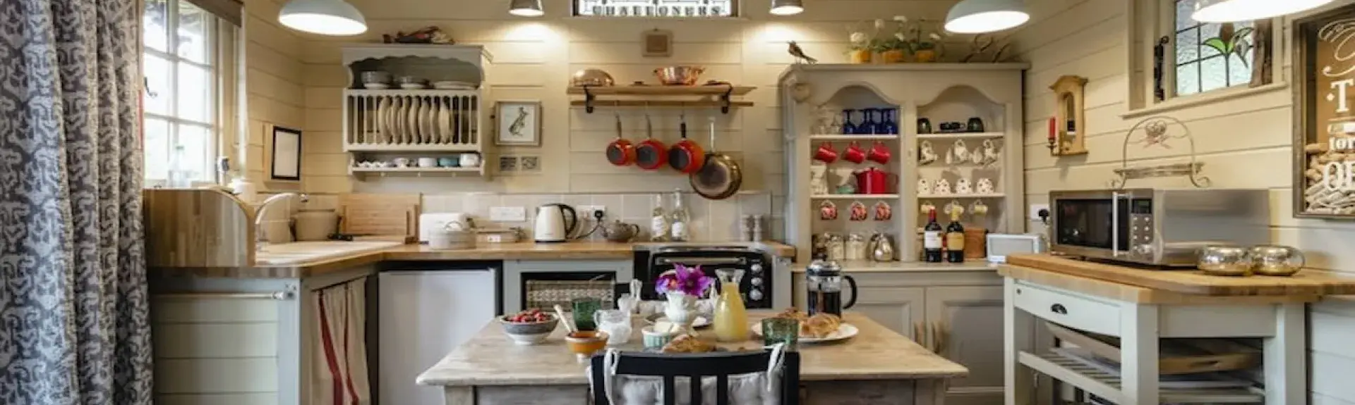 A well-equipped cottage kitchen with breakfast table.