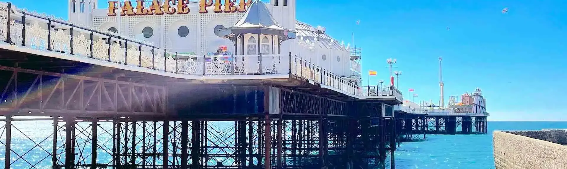 View of the entrance to Brighton Palace Pier looking out to sea.