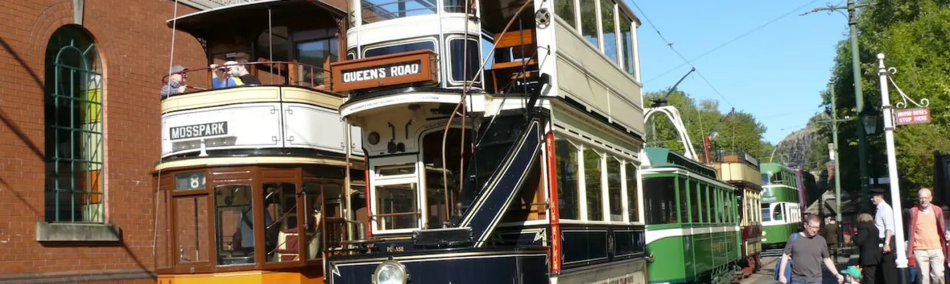 Three vintage trams on a sunny day at the Crich Tramway Village