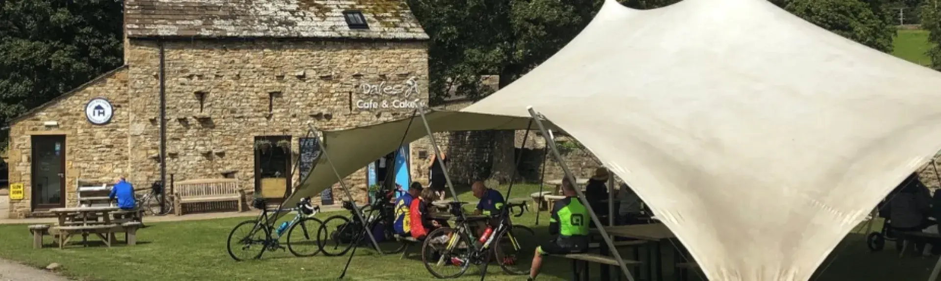 A  Yorkshire Dales tearooms in an open-sided tent being used by cyclists.