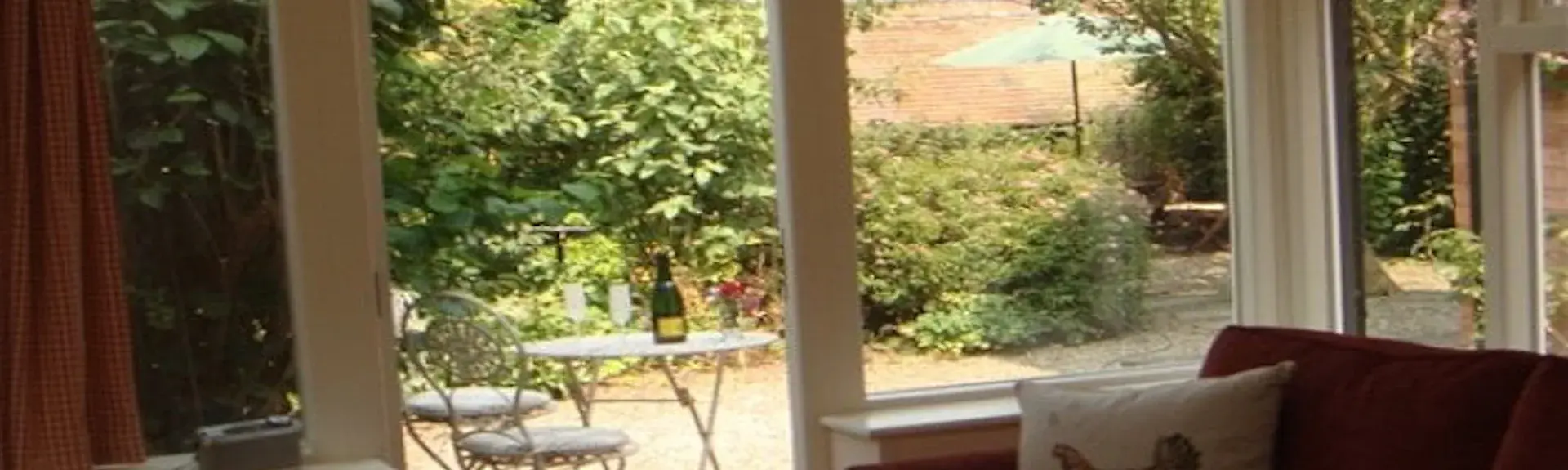 The terrace seen through French windows in the lounge at The Little Bothy.