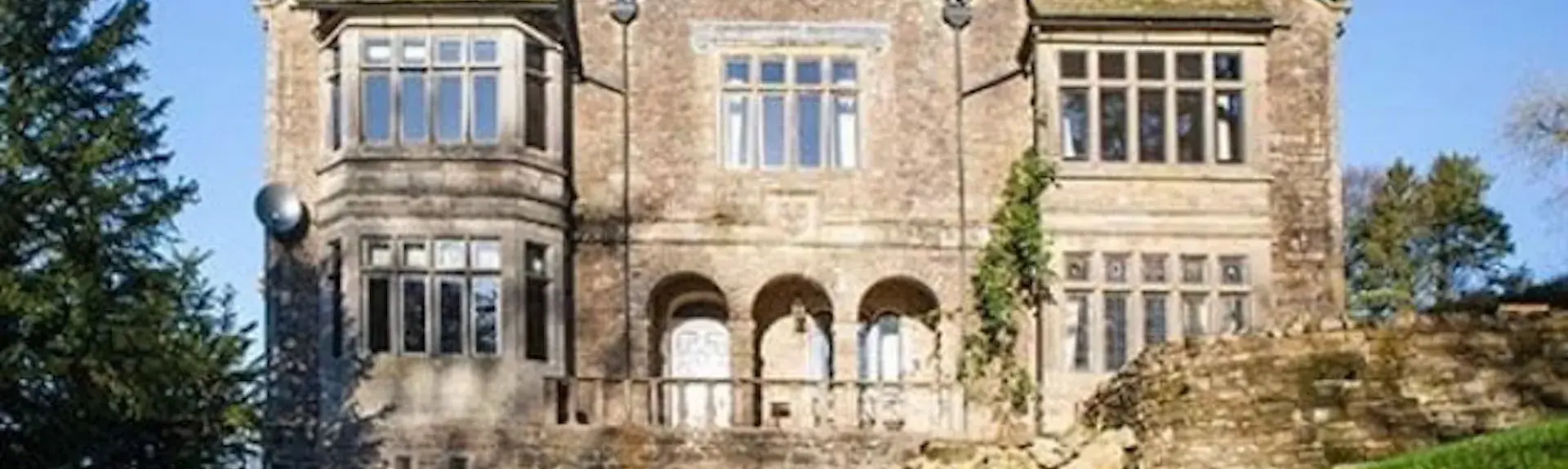 Oughtershaw Hall - a stone-built country house with mullioned bay windows.