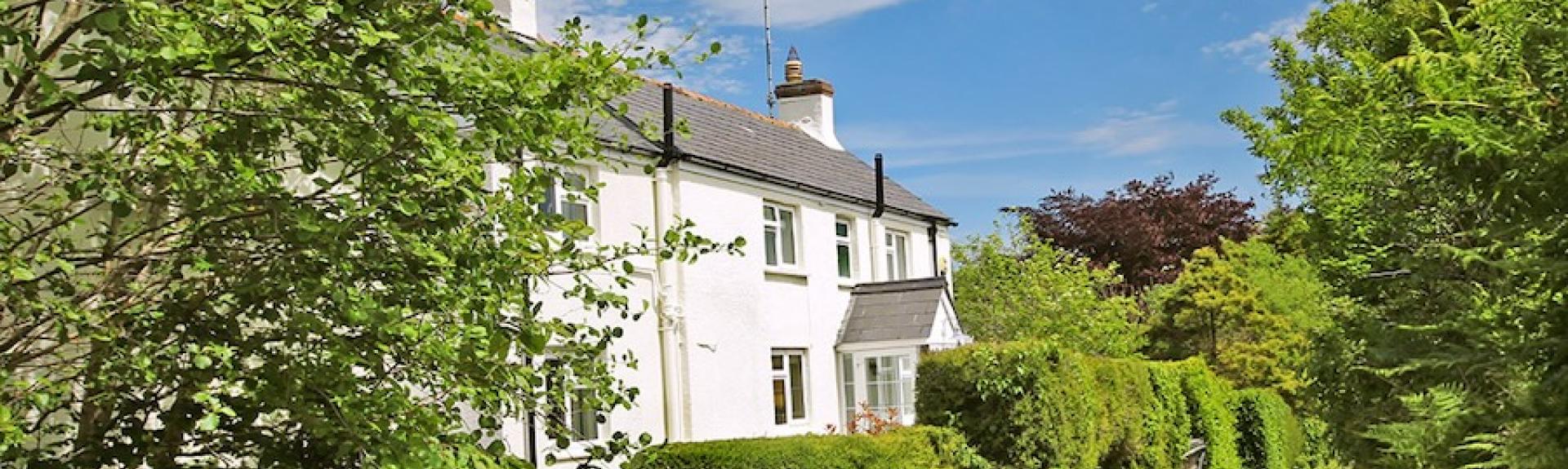 A country cottage in an elevated position overlooks a quiet country lane in North Devon. 