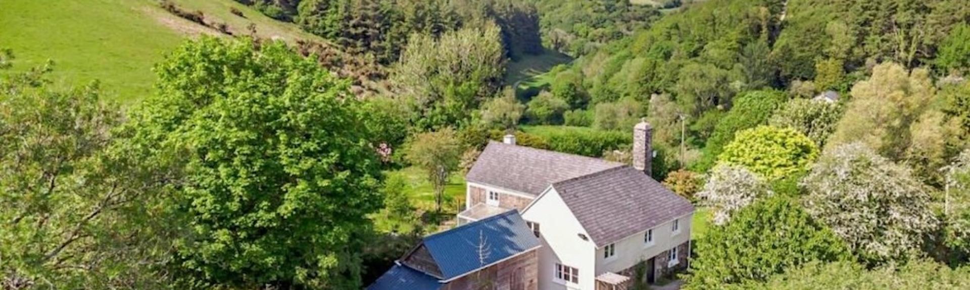 A large Exmoor holiday cottage nestles in a remote wooded valley.