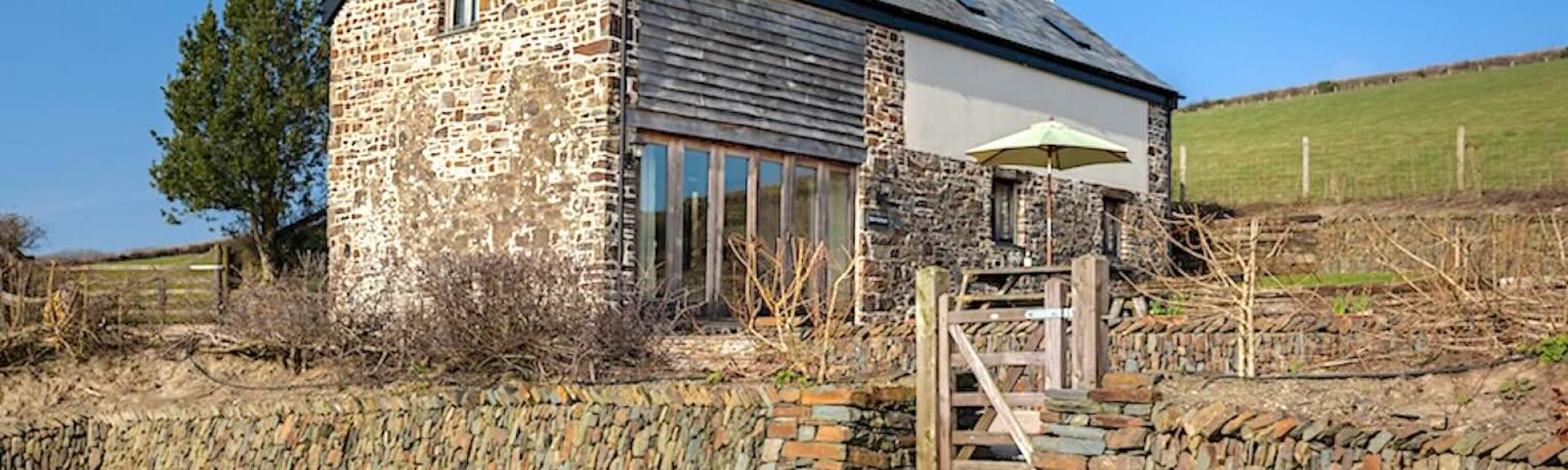 A stone-built Exmoor barn conversion in open countryside.