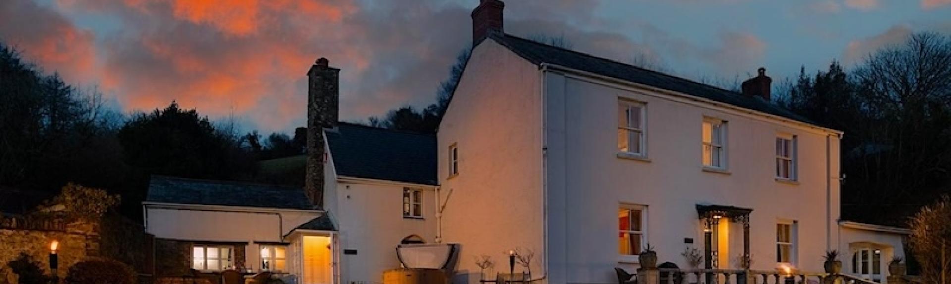 A large country house at dusk.