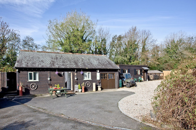 A single-storey wooden holiday lodge in St Columb Major