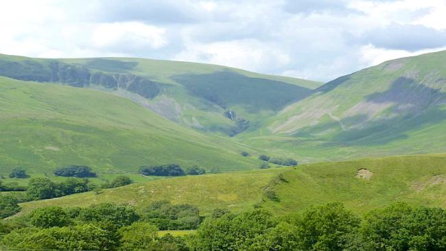 A. view of a large, remote Pennine valley and hills