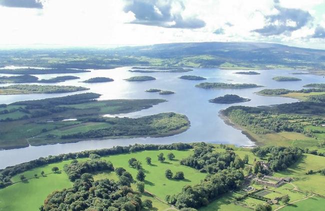 An aerial photo of a large lake dotted with tiny islands