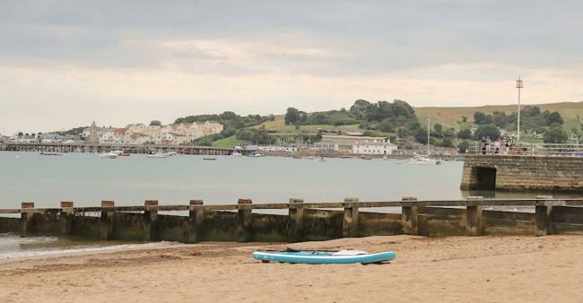 A beach scene at high tide on the Isle of Purbeck.