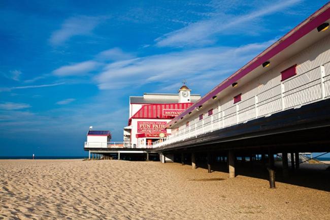 An Isle-of-Wight pier stretches across a sandy beach towards the 