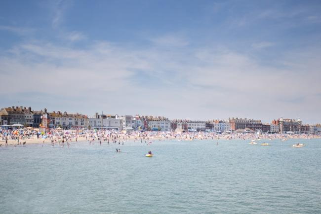 Panoramic photo of Weymouth Beach at high tide on a summer's day