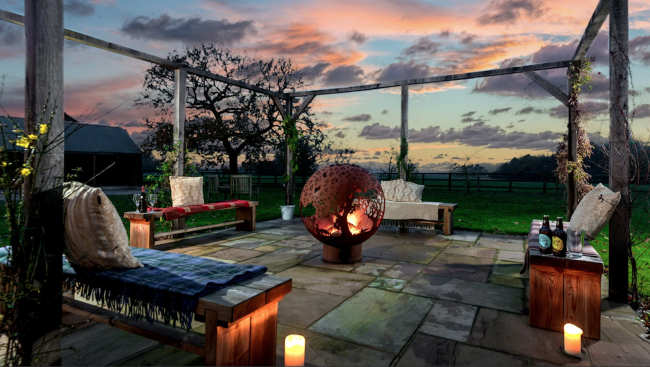 Holiday cottages in the Yorkshire Wolds: The terrace at Broadgate Farm in the sunset - A Luxury Holiday Cottage.